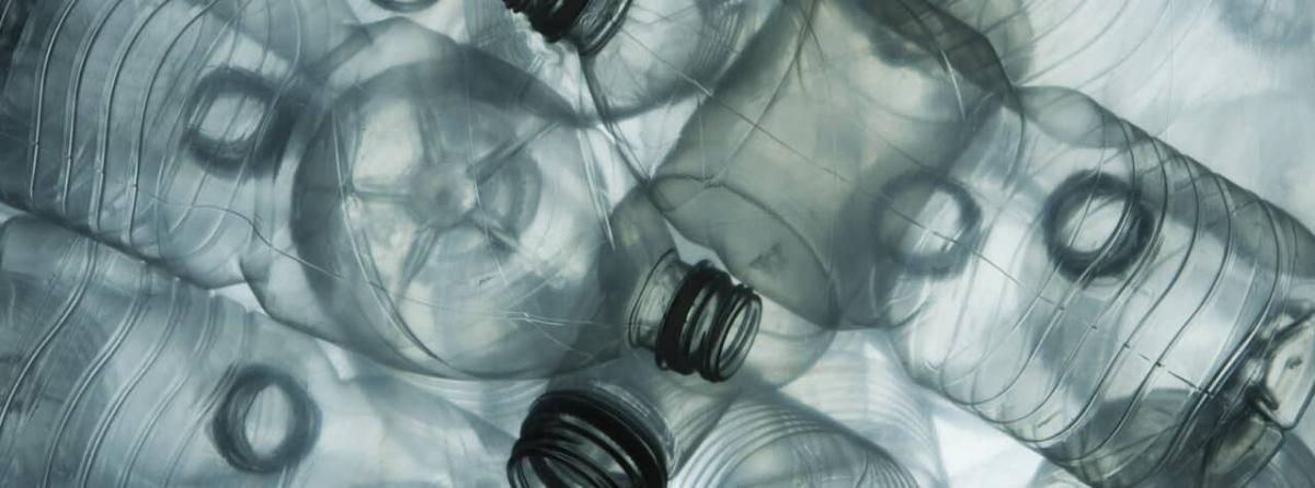 close up to a pile of clear plastic bottles.