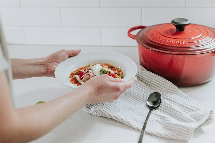 A person holding a bowl of food