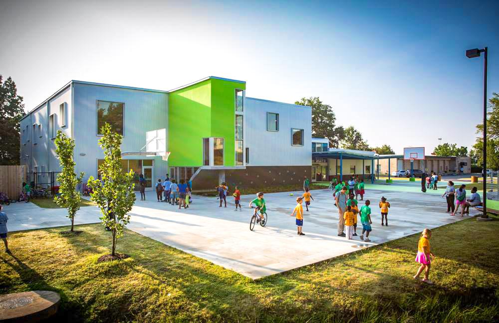 Children playing in a courtyard outside a building.