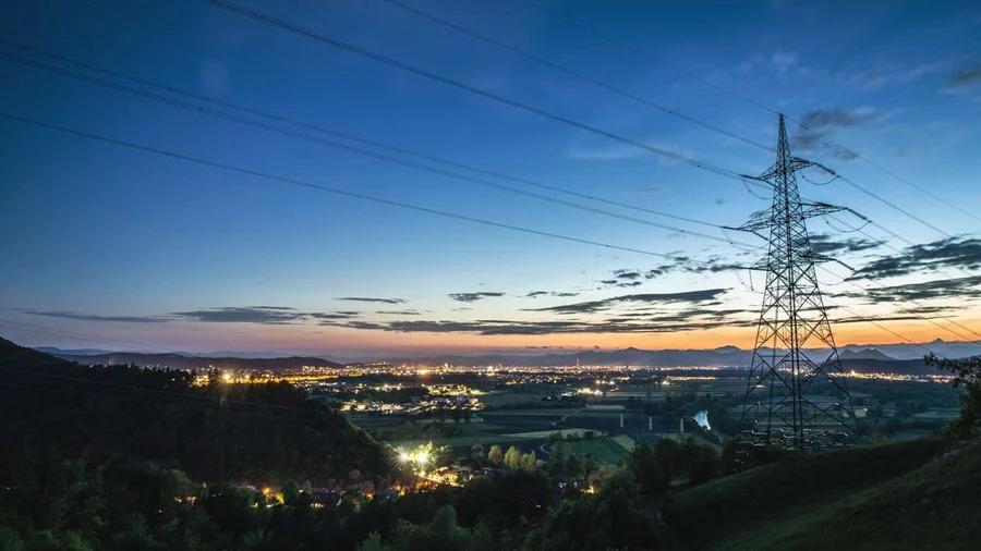 Power lines and a sunset behind.