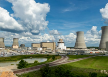 Panoramic view of a power station, partly cloudy sky.