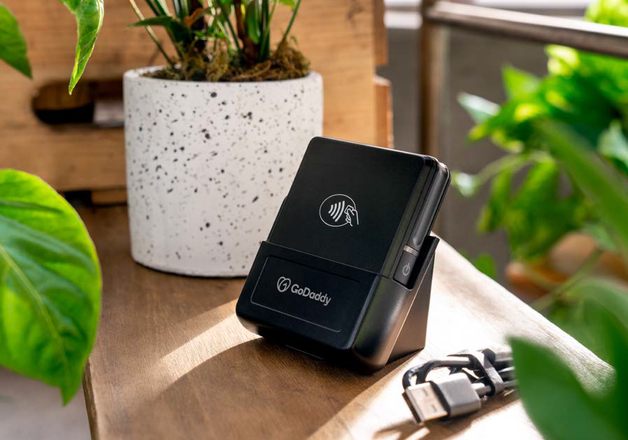 card reader in a window sill next to a potted plant