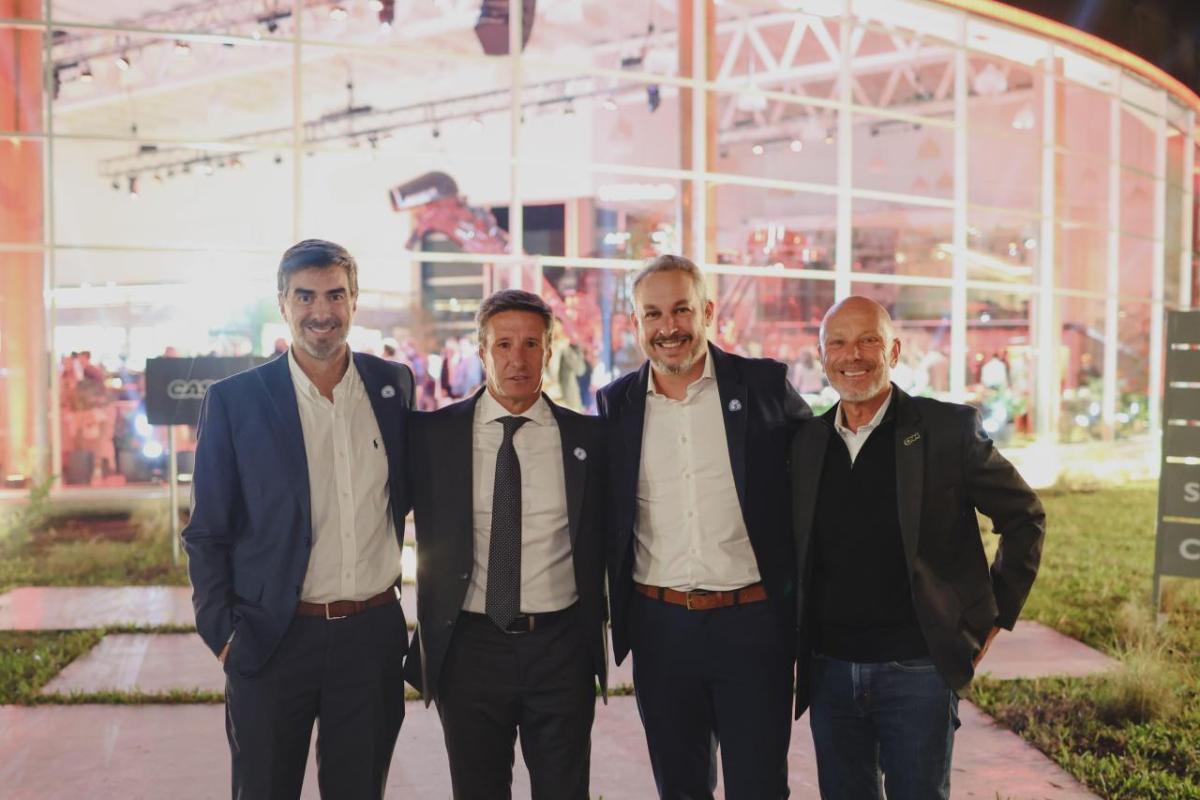 Four people standing in front of dealership