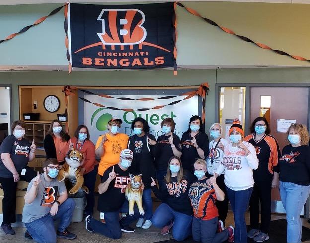 group photo with Bengals flag in background