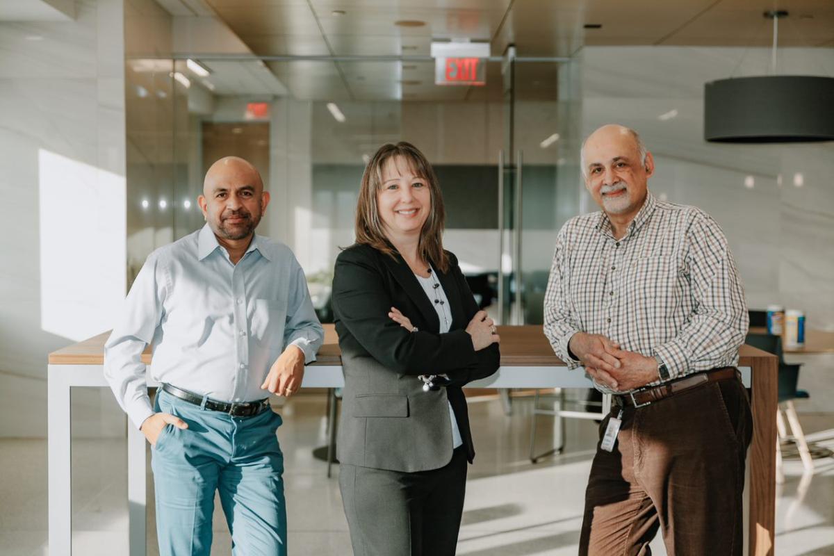 (L to R) Gopi Reddy, Linda Kasulke, and Ayman Alamy are members of Rockwell’s Faith Friendly & Allies employee resource group. 3 people standing together smiling