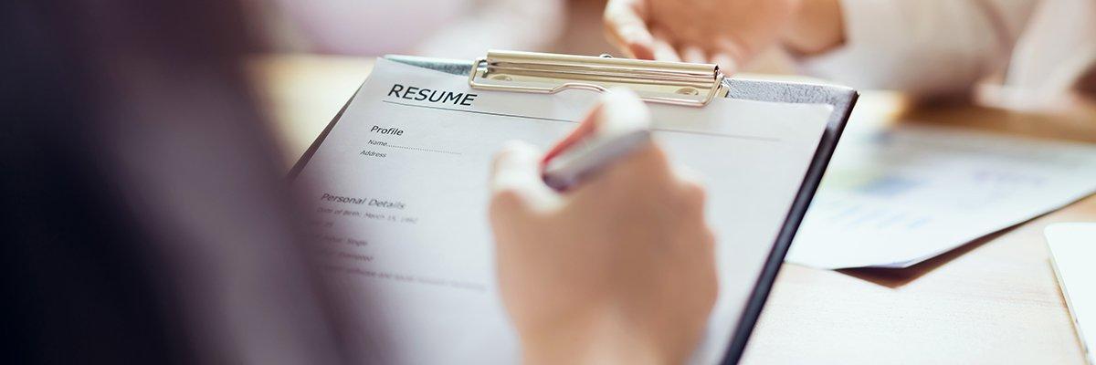 person with a clipboard with a resume
