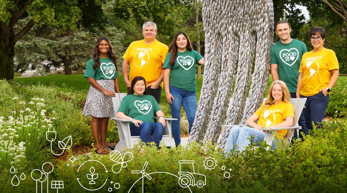 People standing and sitting outdoors in yellow and green tee shirts