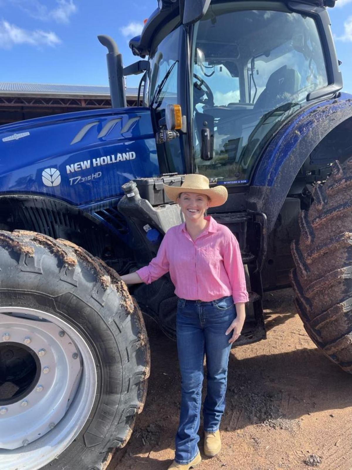 A person standing by a tractor