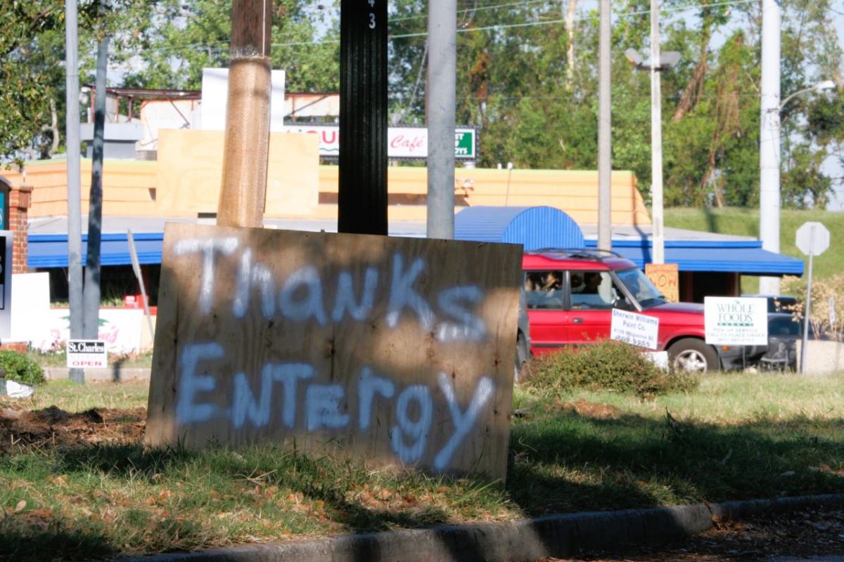 A spray-painted piece of plywood that says "Thanks Entergy"