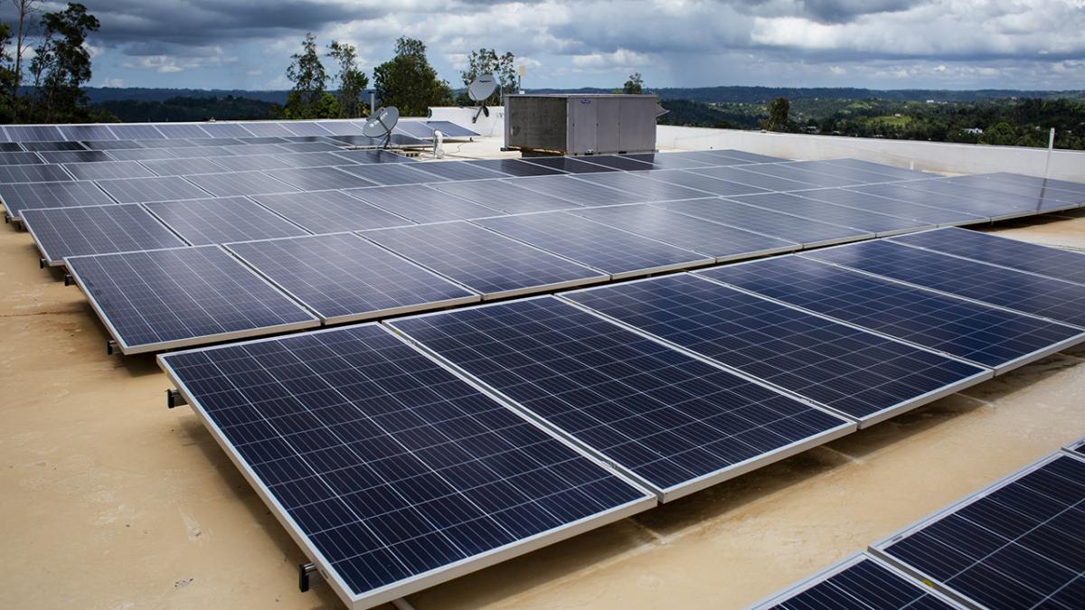 Solar panels line the roof of a health center.