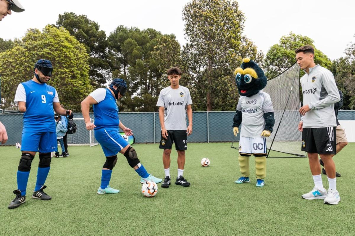 LA Galaxy players and the club’s mascot join adaptive athletes on the field for a skills session during the LA Galaxy Foundation Youth Adaptive Sports Program, reinforcing the power of sport to build confidence and community.