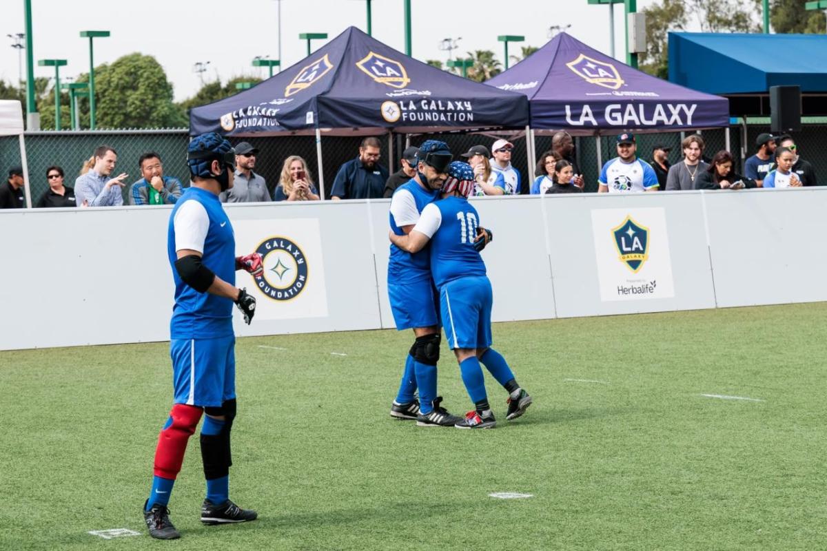 Team celebrate a moment on the field, highlighting the inclusive environment that allows athletes of all abilities to experience the game of soccer.