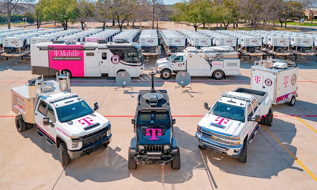 An aerial view of a fleet of emergency response vehicles with the T-Mobile logo on them.