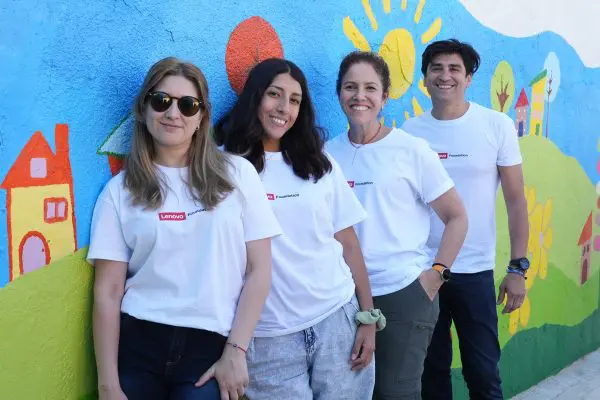 4 people in white t-shirts leaning against a mural