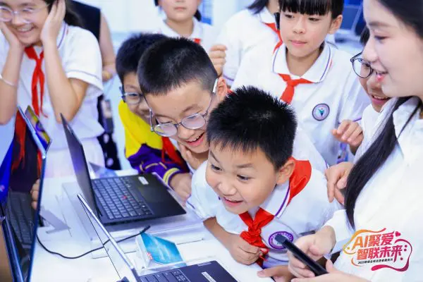 children having fun looking at laptops together