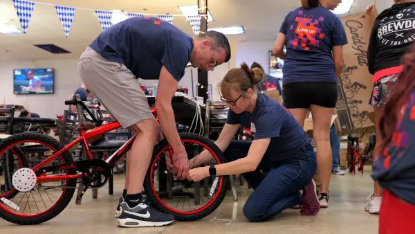 2 people adjusting a bicycle