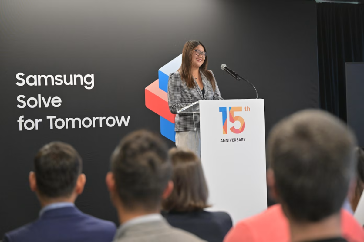 A speaker at a podium addressing an audience