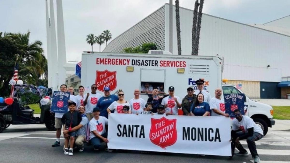 A group posed with a banner "Santa Monica Salvation Army" in front of a box truck. "Emergency Disaster Services" on the side.