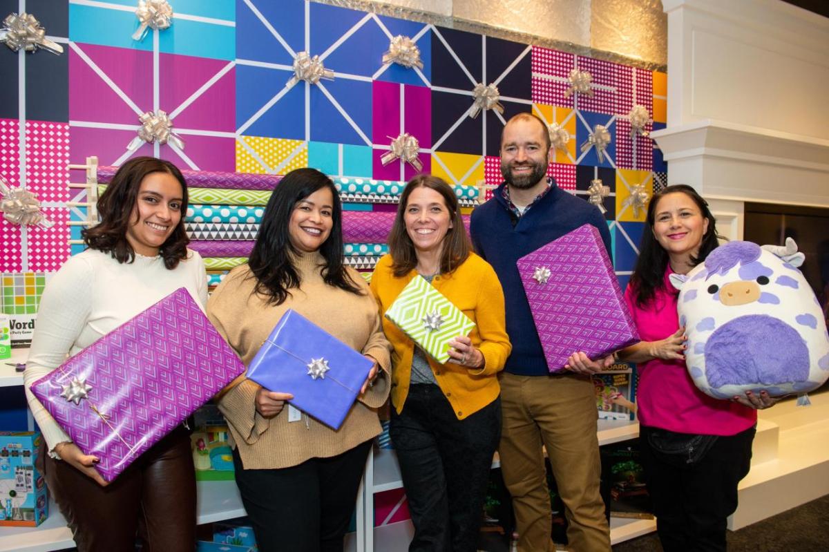 Group holding wrapped gifts