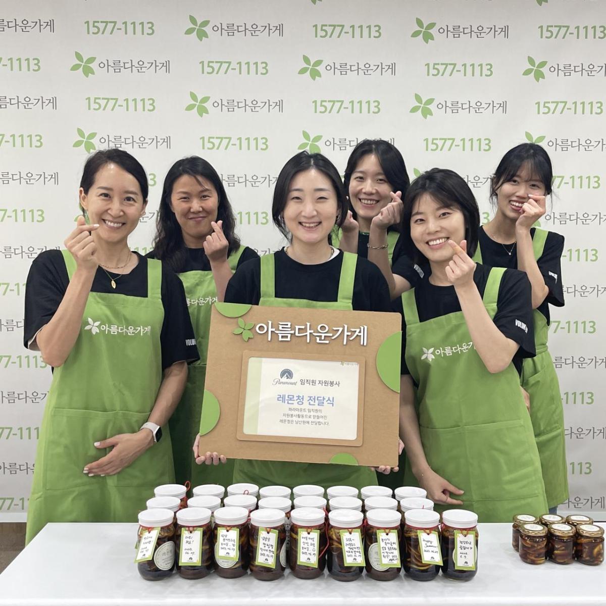 volunteers wearing green aprons