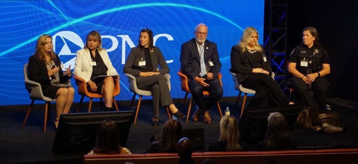 Six panelists on stage with PNC logo behind them