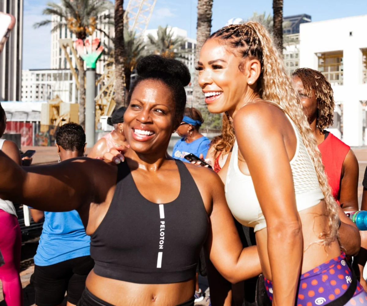 Two people wearing Peloton workout gear taking a selfie