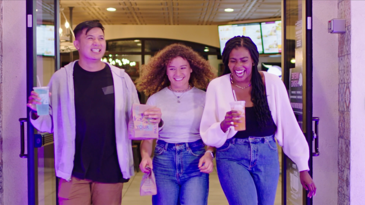 Three people laughing and walking together