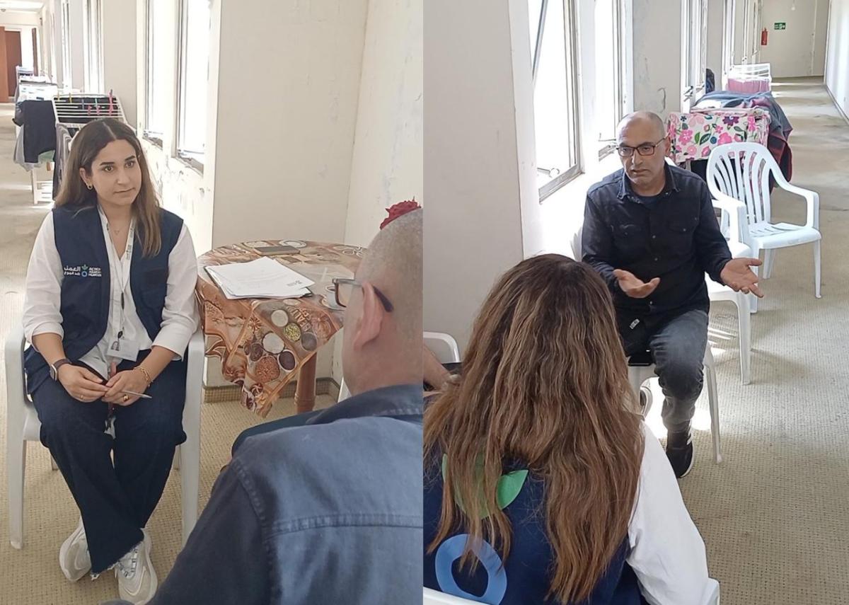 Mahmoud tells an Action Against Hunger staff member about his experience. 