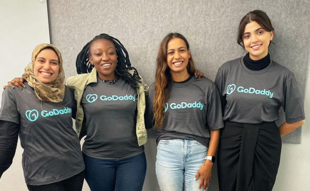 four women wearing the same "GoDaddy" shirt