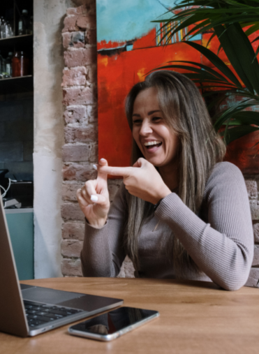 a person signing 'friend' to a laptop screen