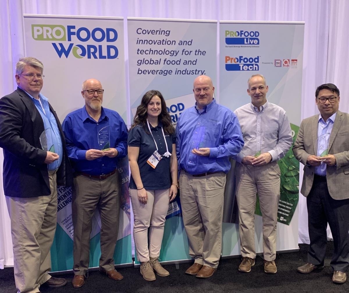 Carter Hansen, director of environmental affairs for Smithfield Foods (pictured left), with 2018 Sustainability Excellence in Manufacturing Award winners at ProFood Tech in the Innovation Zone.