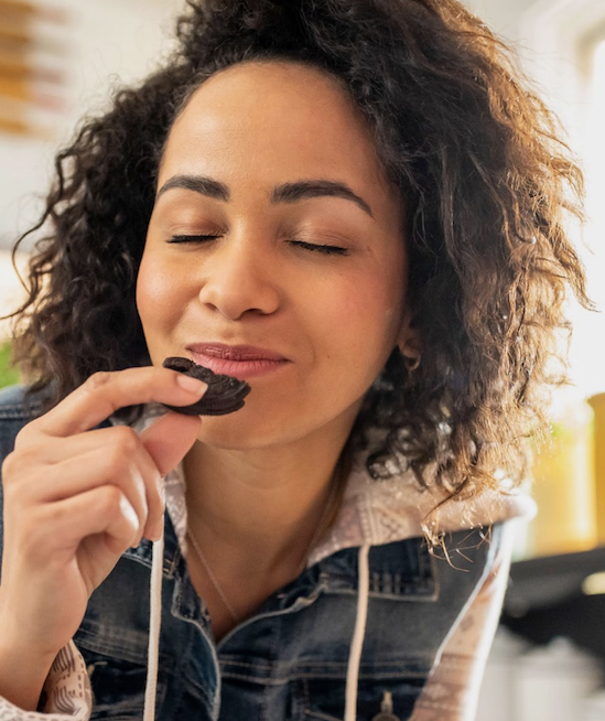 A person eating a biscuit