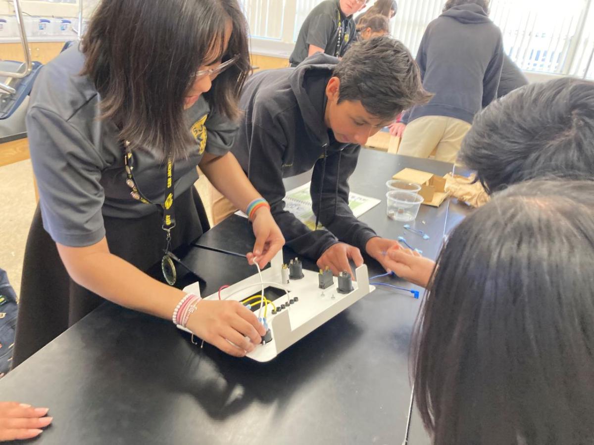 A team of students working on solar battery kit.