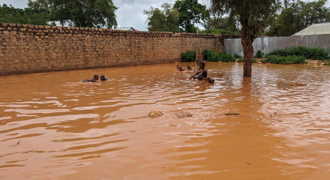 Children play in a pool of water in Baidoa. During the heavy rains, cholera and water borne diseases are common and risk the lives of vulnerable families.