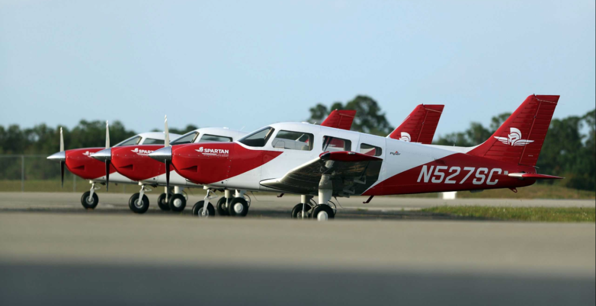 Three small planes parked on a runway
