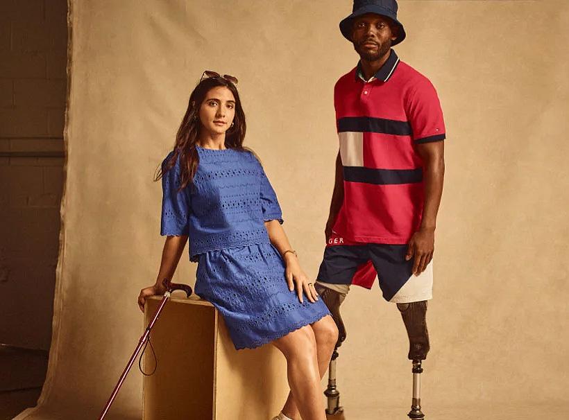 A female model with a cane and a male model with prosthetic legs.