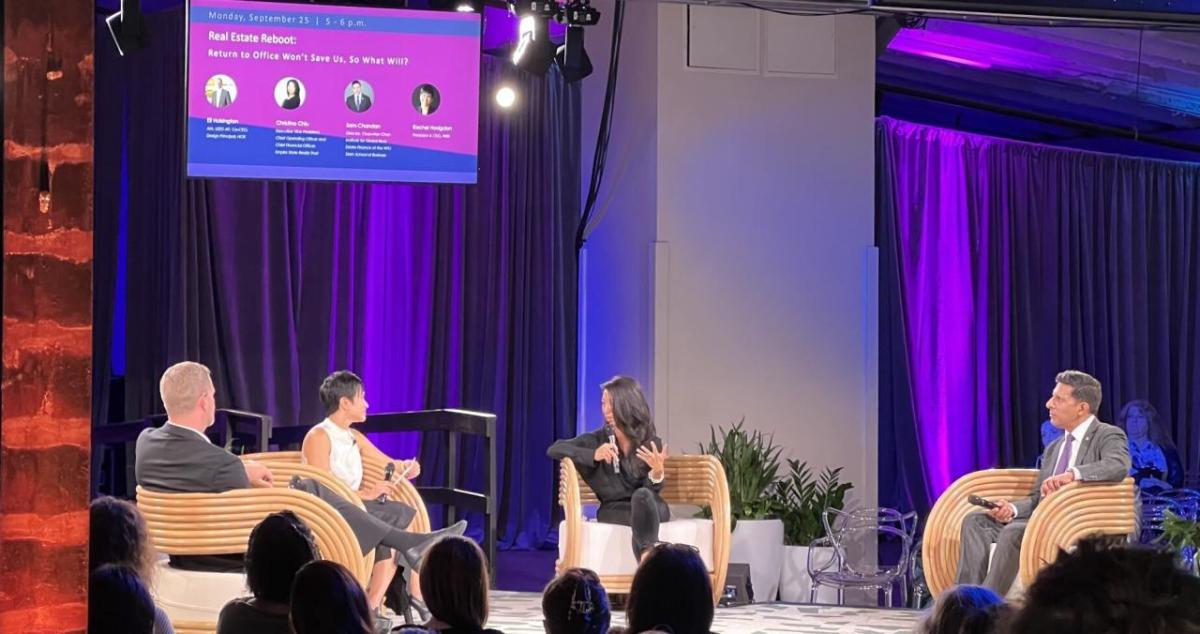 Four people having a discussion on stage