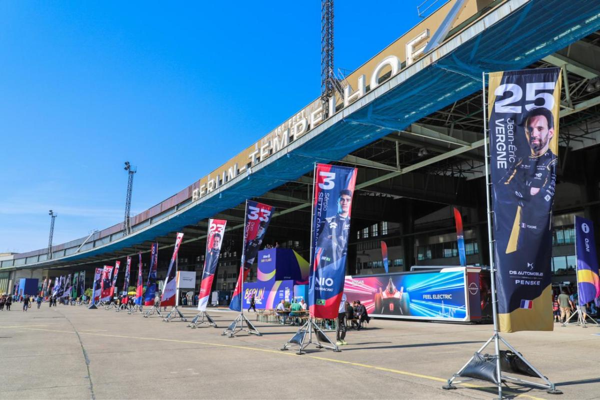 Banners for race care drivers on a track.