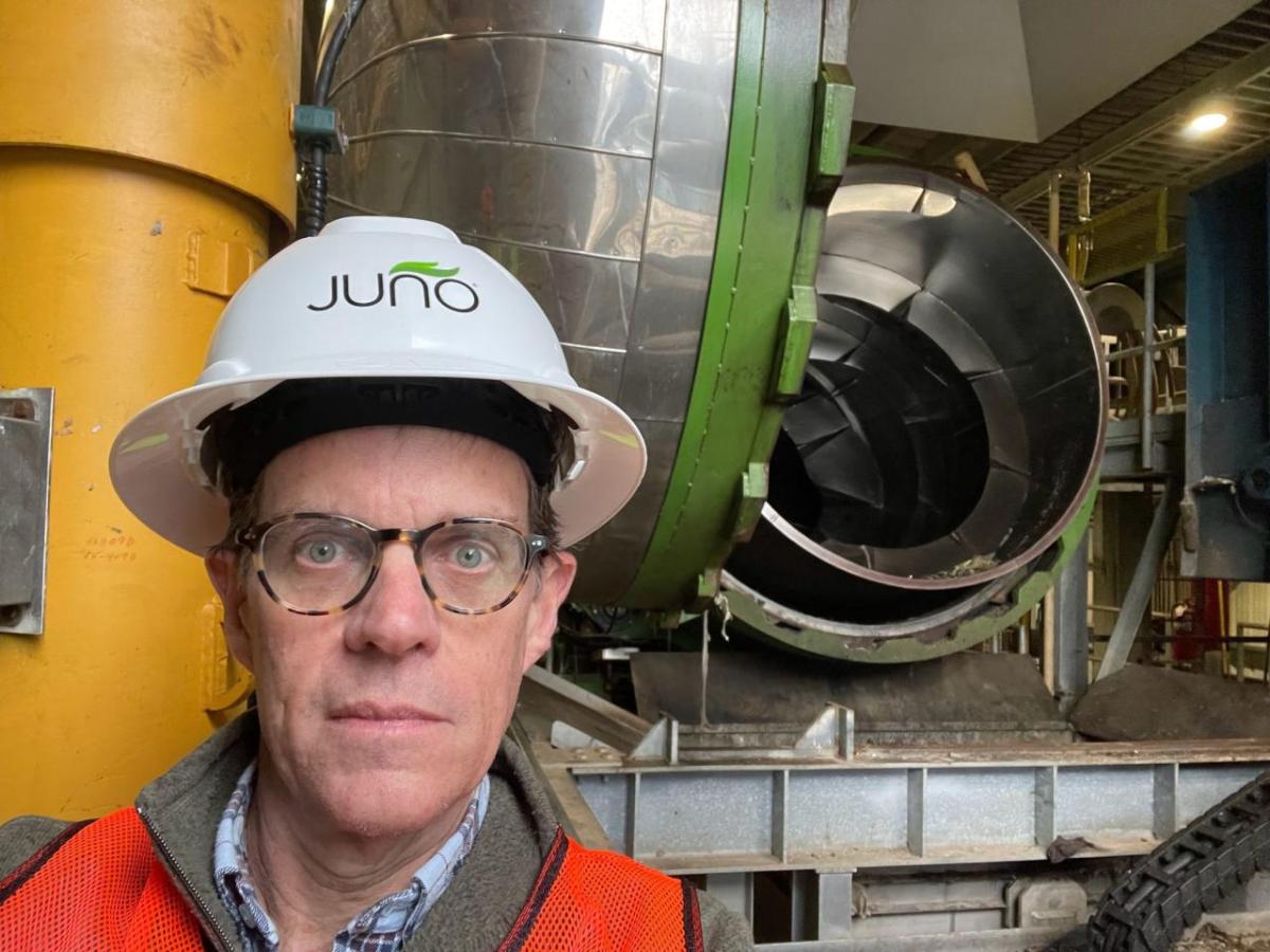 John Mulcahy in front of a large machine.