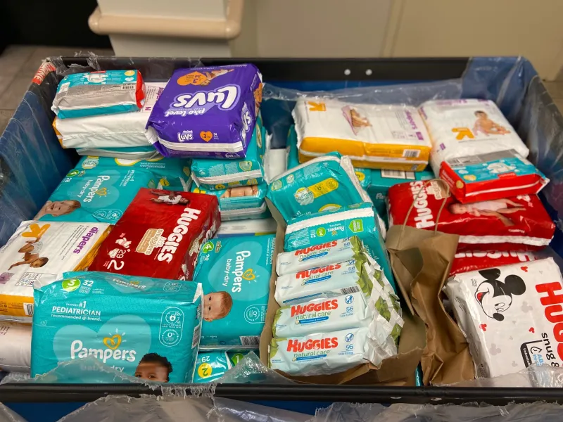 A bin of new, packaged diapers