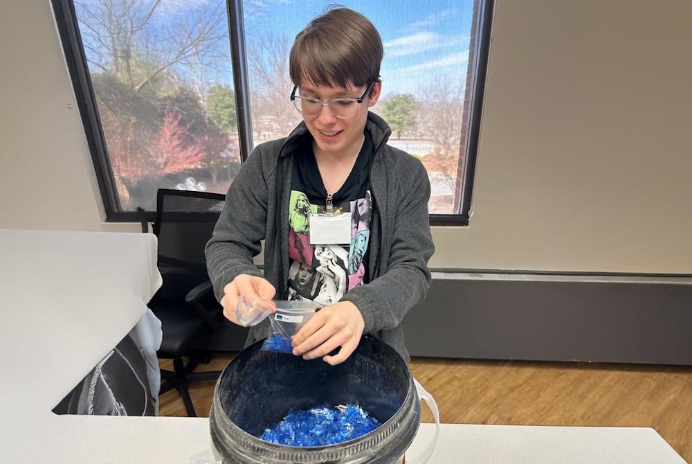 Student fills a sample bag.