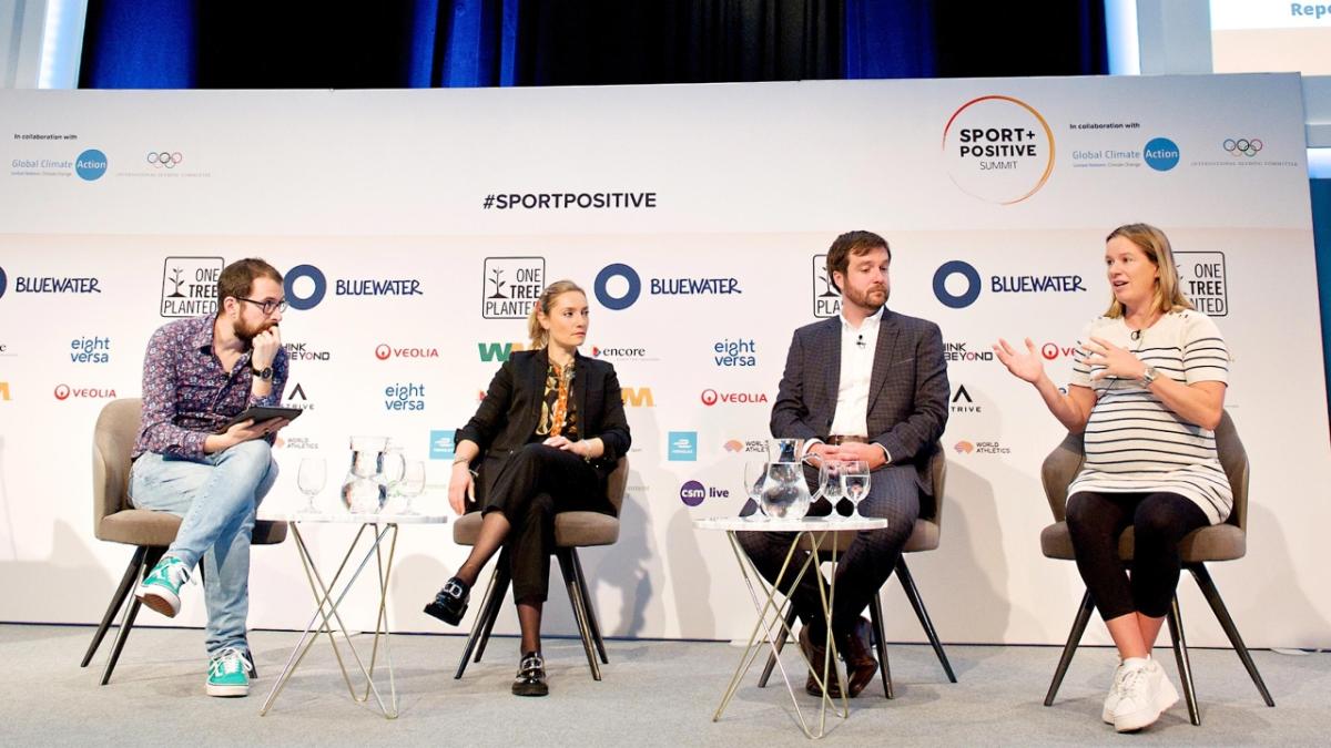 four people seated on a stage