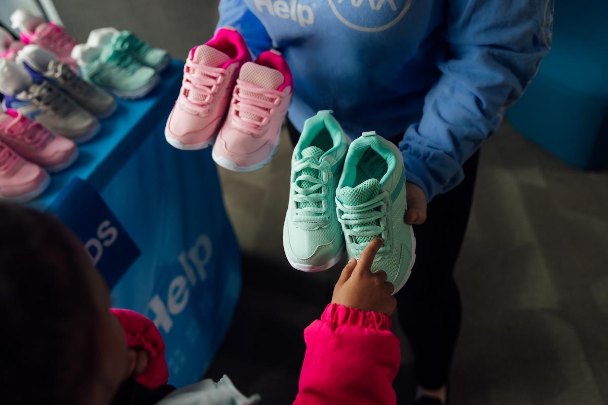 people holding children's shoes
