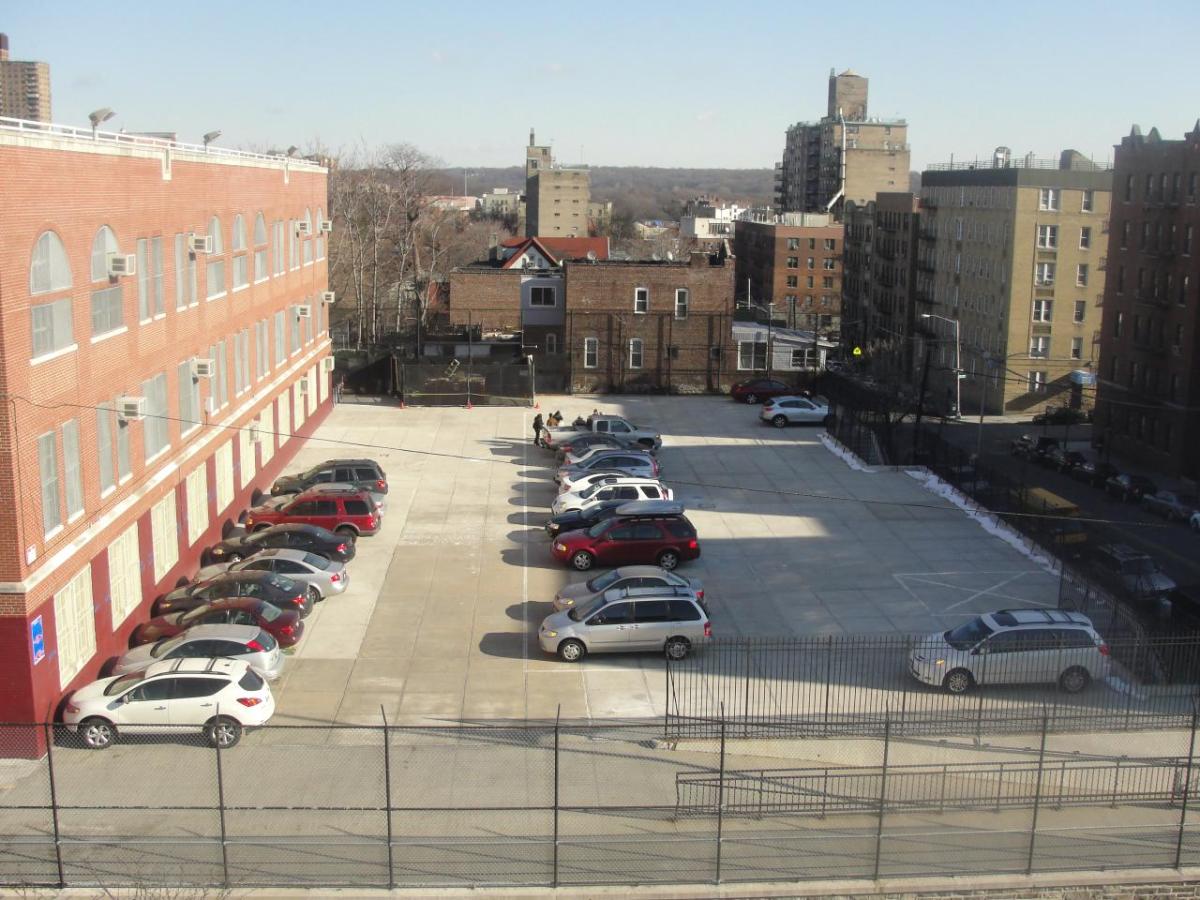 Cars parked between buildings