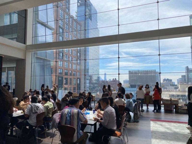 people seated in a large open room at small tables