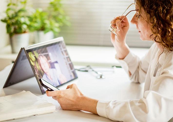 person looking at a tablet and a smart phone