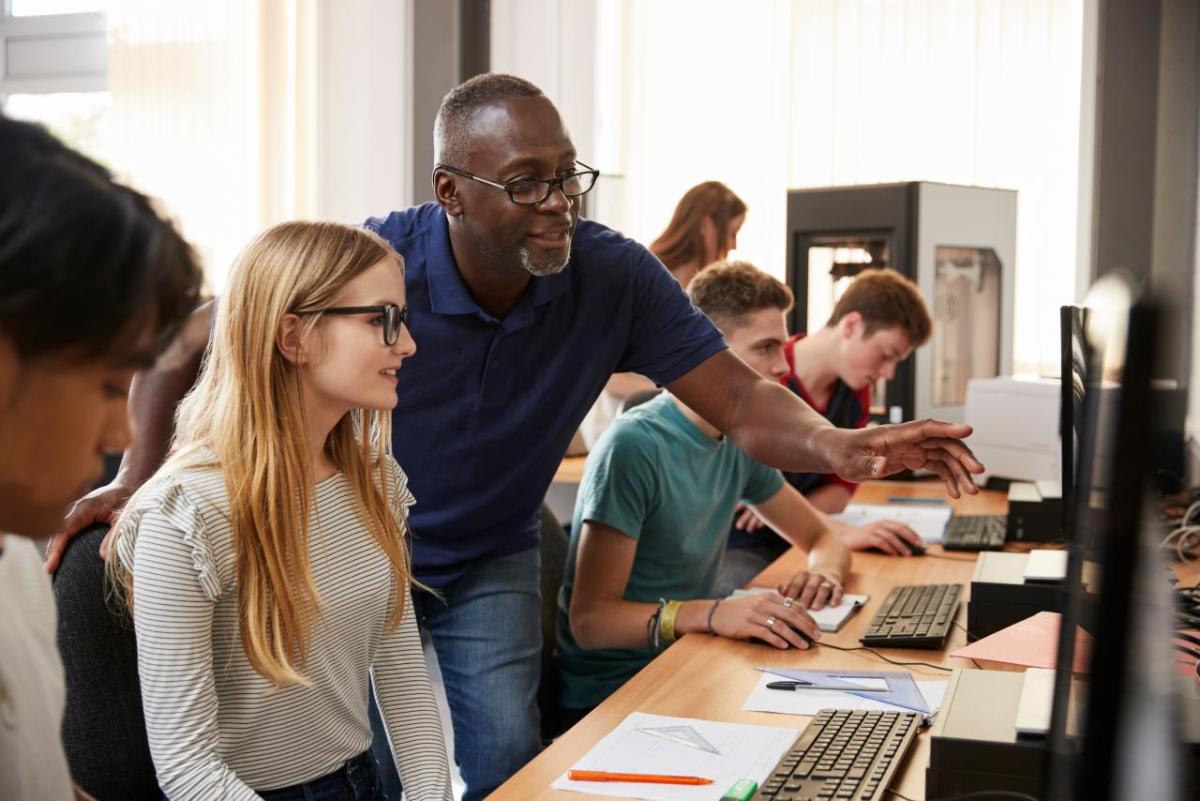 teacher and students on computers