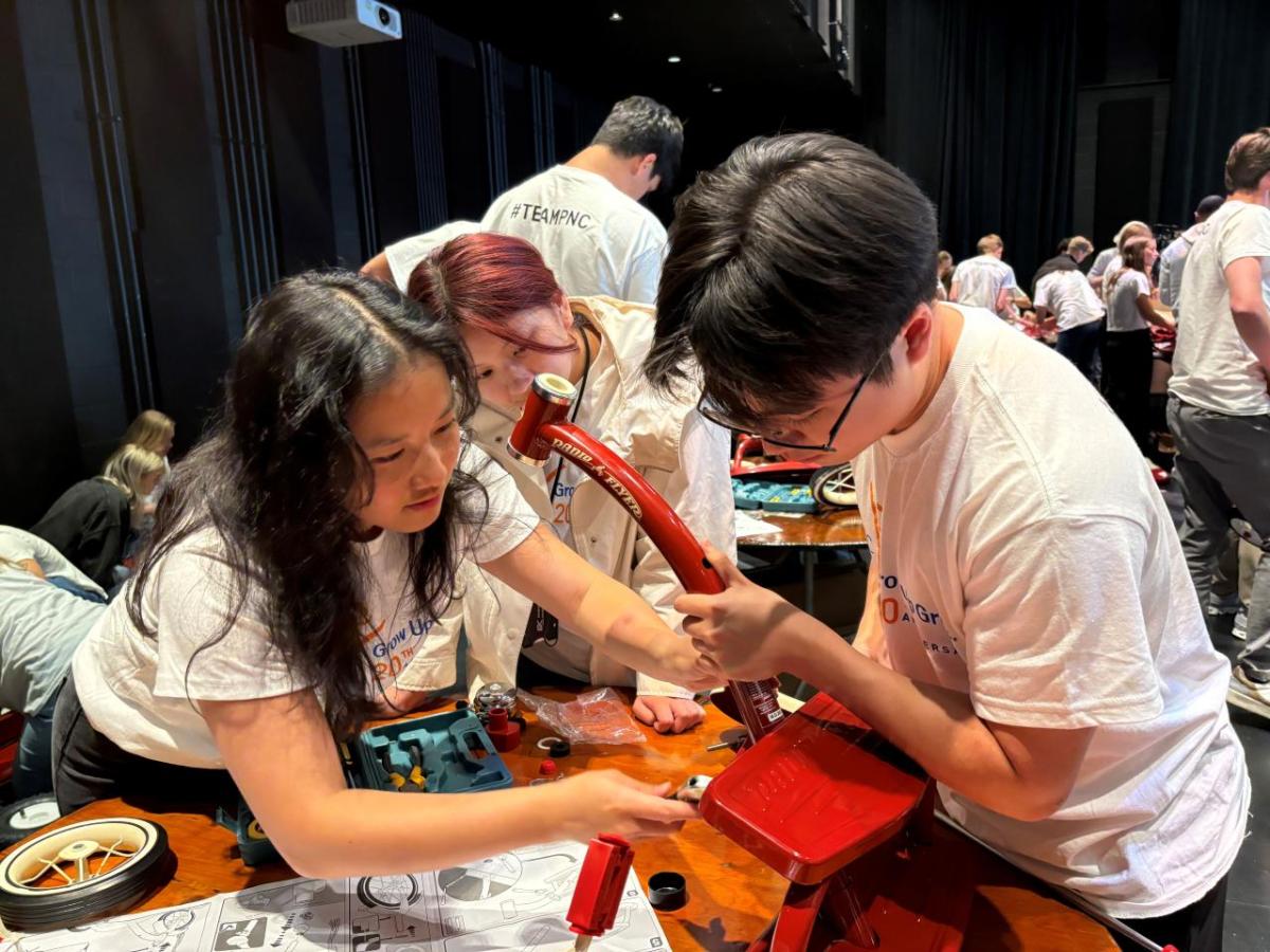 Interns and volunteers working together to assemble bikes and wagons.