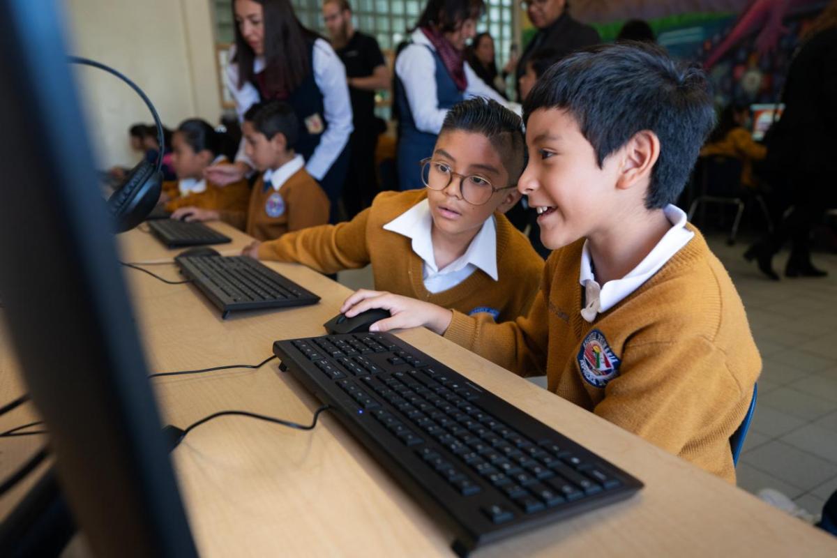 Children working together on laptops
