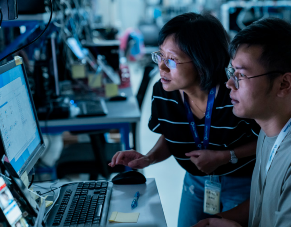 Two people looking at the same computer screen.